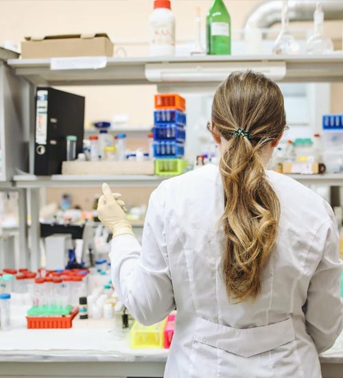 Lady Technician working in the lab background image
